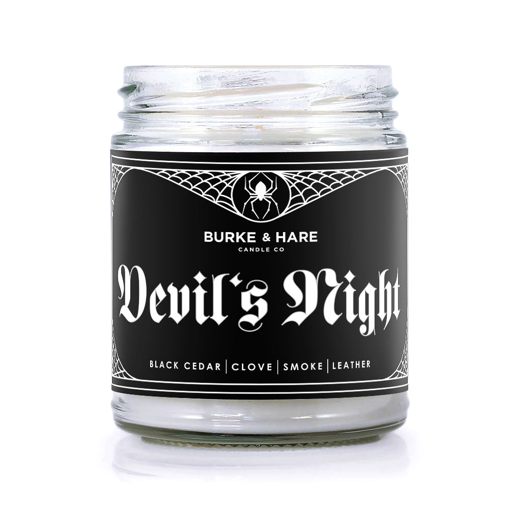 goth scented candle inspired by the movie the Crow with black label with a spiderweb border and white text reading Devil's Night