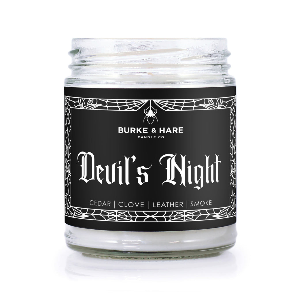 goth scented candle inspired by the movie the Crow with black label with a spiderweb border and white text reading Devil's Night