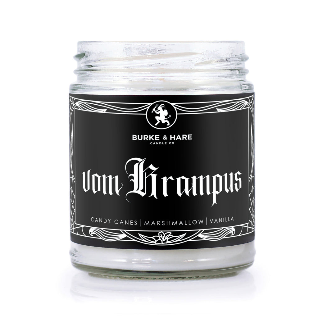 Peppermint scented candle with a black label and white text that says Vom Krampus in gothic font. Label has an illustrated krampus and gothic border details.