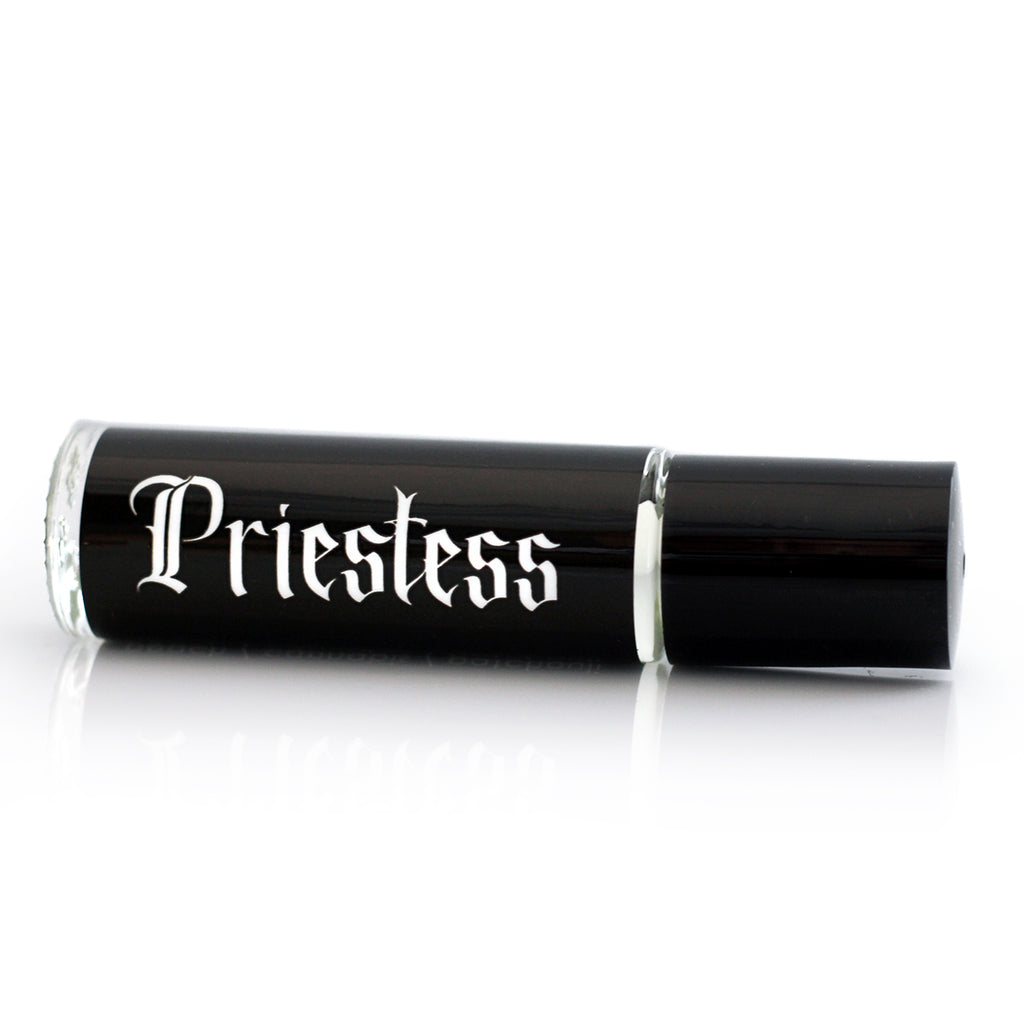 witchy scented perfume in a roll on vial with a black label with white gothic lettering that says Priestess.