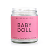 90s themed scented candle with a pink label and black text that says Baby Doll  and "i want to be the girl with the most cake"