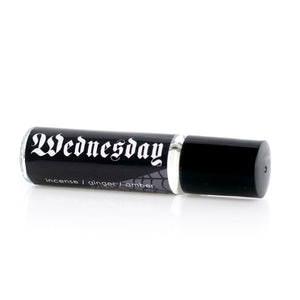 goth girl perfume oil in an 8ml glass vial with a black label and white text that reads "Wednesday" in gothic font