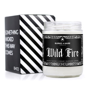 bonfire scented candle with black label and white gothic font that reads "wild fire"