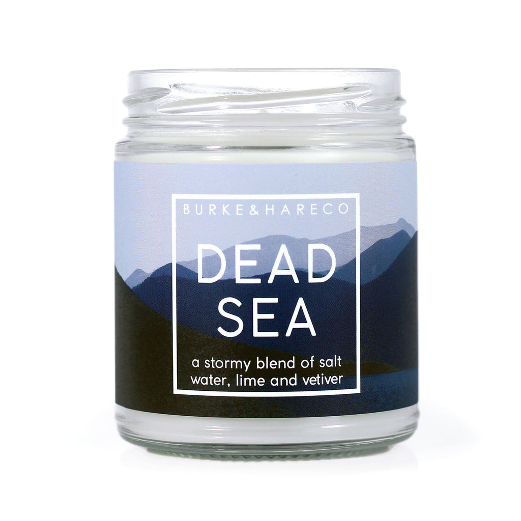 Ocean Scented Candle with a blue label that has mountains and water on it. White text says "dead sea"