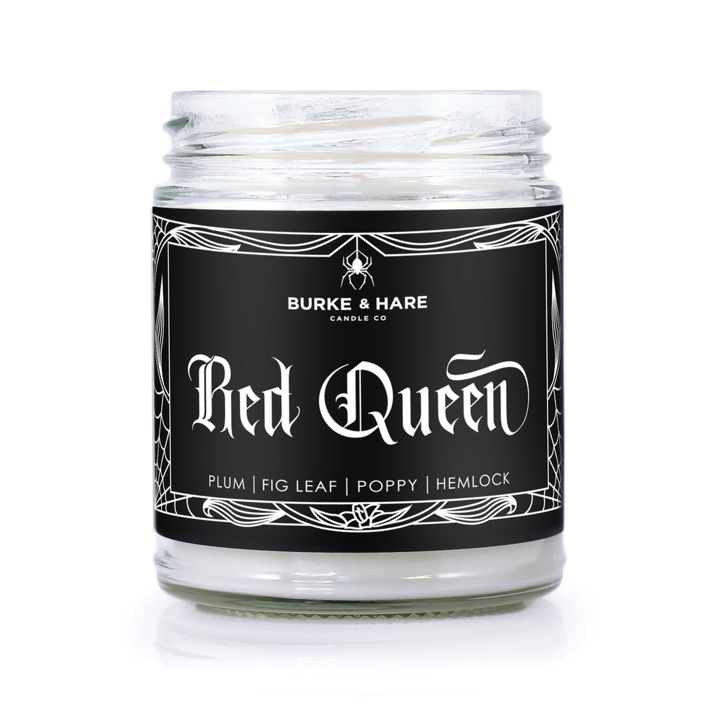 Witchy Scented candle with black label that has a spiderweb border and says Red Queen in gothic font