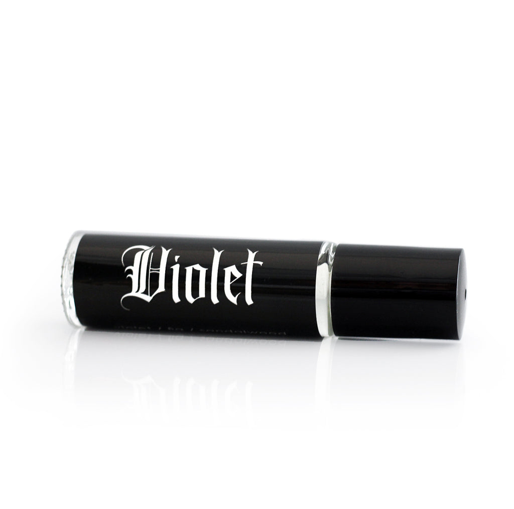 witchy scented perfume in a roll on vial with a black label with white gothic lettering that says Violet