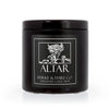Rose scented black candle in a black tin with  a white rose illustration on the label and white text that says Altar. Vampire candles