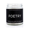 Book scented candle with black label and white text that says Poetry and in small font reads "inspired by worn covers, bent pages and the dusty shelves of an old library" on the bottom.