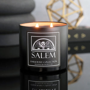 Goth scented candle in a black tin with a black label that has a white illustration of a vintage headstone and says Salem in white font
