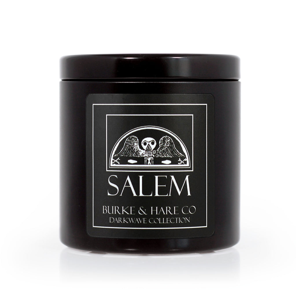 Salem Inspired Scented Candle in a Black tin with an old headstone image on a black label with white text.