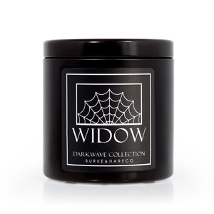 Wednesday Addams inspired scented candle in a black tin with a black label that has a spider web on it and reads WIDOW in white text