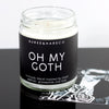 scented candle with black label and white font that reads Oh My Goth sitting on an image of a goth model 