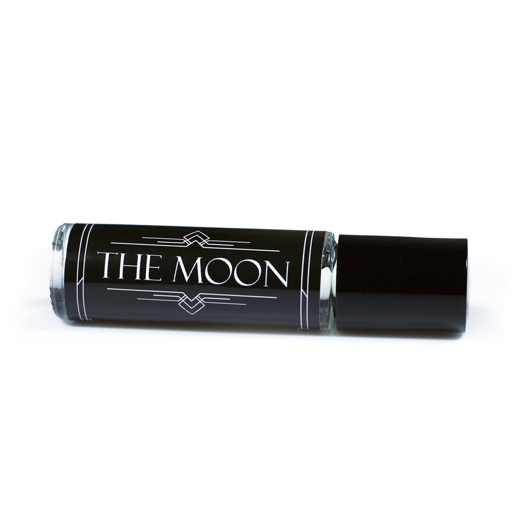tarot card inspired perfume that smells like lavender and honey in a 8ml roll on vial with a black label and white text that says "the moon"