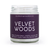 velvet woods scented soy candle with purple label and white text
